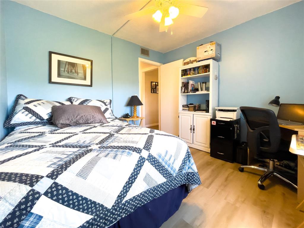 330 Knotty Pine Circle, Unit A1 Greenacres, FL 33463 - Photo 15 of 30 a bedroom with a bed and wooden floor