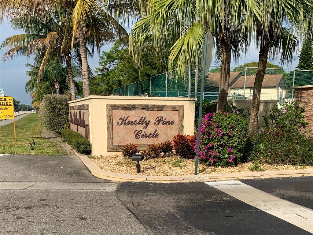 330 Knotty Pine Circle, Unit A1 Greenacres, FL 33463 - Photo 19 of 30 a sign board with palm trees