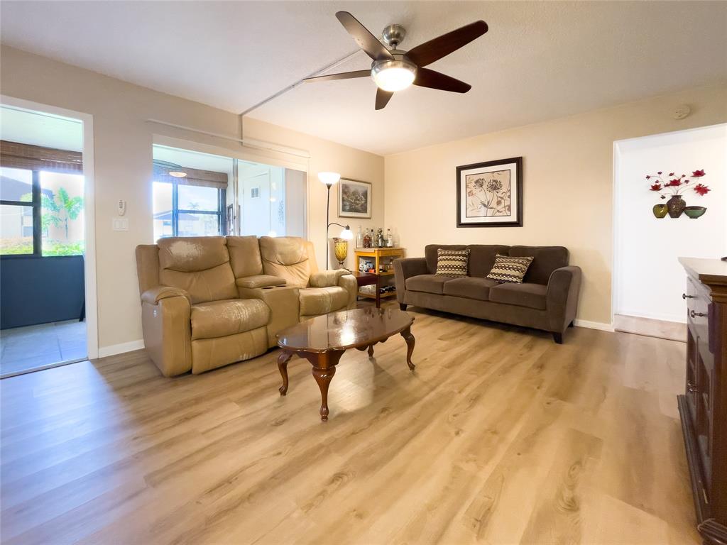 330 Knotty Pine Circle, Unit A1 Greenacres, FL 33463 - Photo 2 of 30 a living room with furniture and a wooden floor
