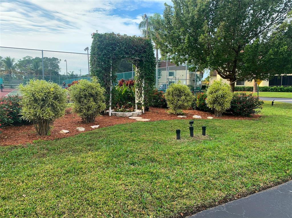 330 Knotty Pine Circle, Unit A1 Greenacres, FL 33463 - Photo 23 of 30 a view of a backyard with sitting area