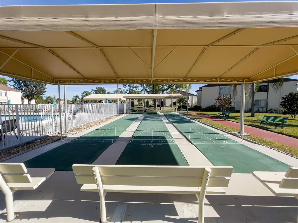 330 Knotty Pine Circle, Unit A1 Greenacres, FL 33463 - Photo 27 of 30 a view of a swimming pool with a patio