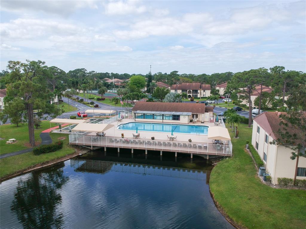 330 Knotty Pine Circle, Unit A1 Greenacres, FL 33463 - Photo 28 of 30 a view of a lake with houses