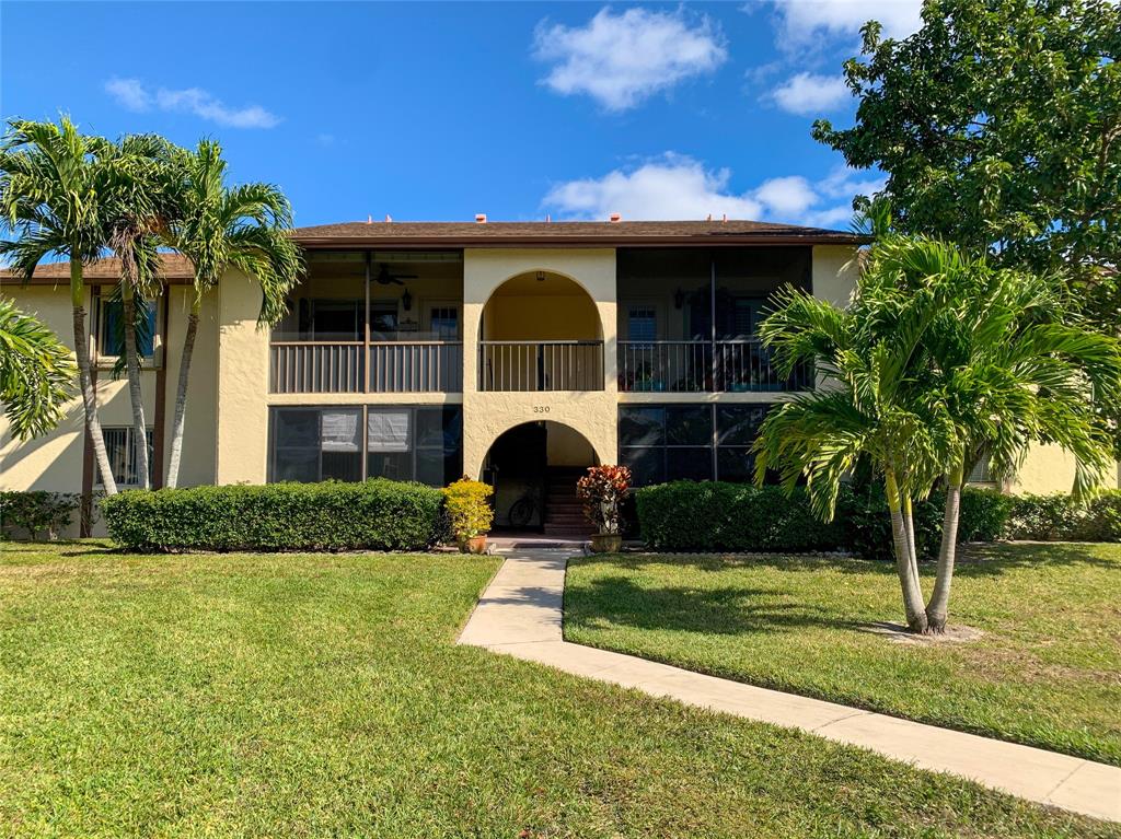 330 Knotty Pine Circle, Unit A1 Greenacres, FL 33463 - Photo 29 of 30 a view of a house with a yard and plants