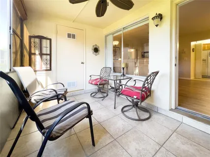 a living room with patio chairs