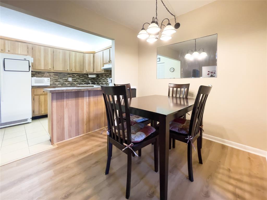 330 Knotty Pine Circle, Unit A1 Greenacres, FL 33463 - Photo 5 of 30 a view of a dining room with furniture and wooden floor