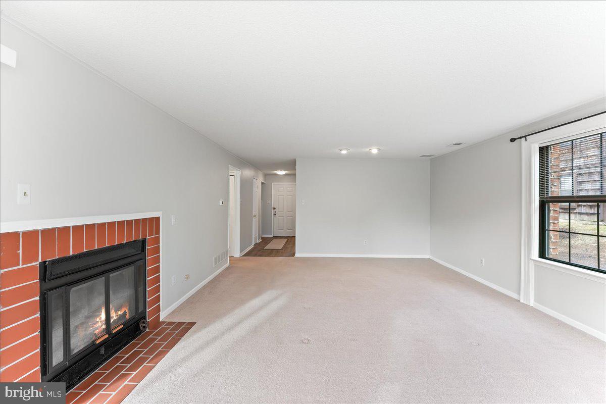 44 Witherspoon Court, Unit 137 Chesterbrook, PA 19087 - Photo 13 of 26 a view of an empty room with window and fire place