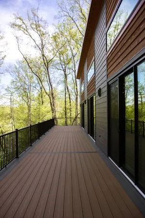 a view of outdoor space with deck and floor to ceiling window