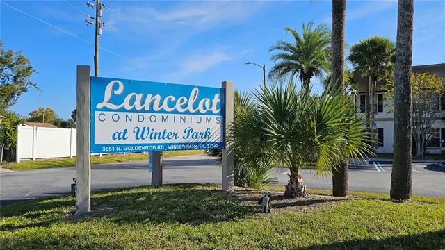 a view of outdoor space with sign board and potted plants