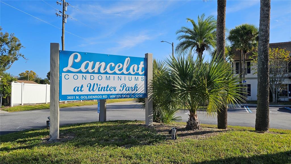 3651 North Goldenrod Road, Unit C205 Winter Park, FL 32792 - Photo 11 of 11 a view of outdoor space with sign board and potted plants