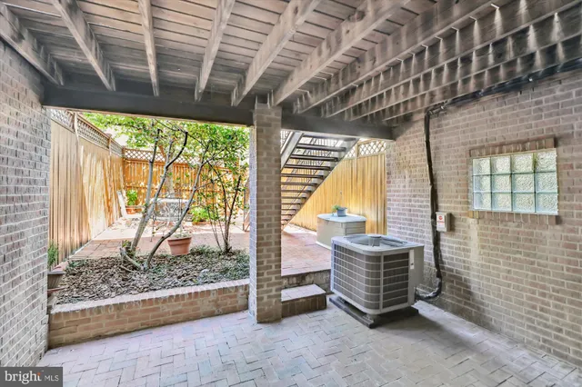 a kitchen with stainless steel appliances granite countertop a refrigerator a stove and a sink with wooden cabinets