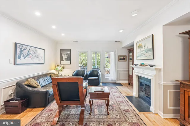 a bedroom with a bed a chair and potted plant