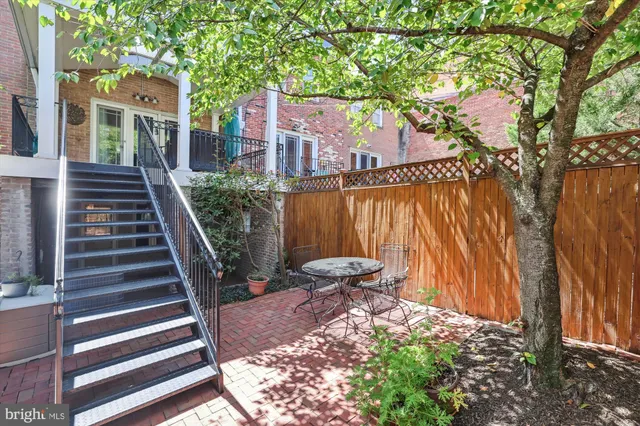 a bathroom with a granite countertop sink toilet a mirror a vanity and shower