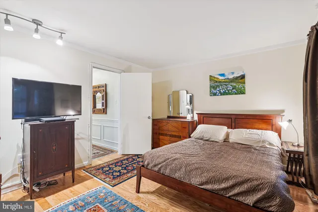 a bedroom with a bed and flat screen tv