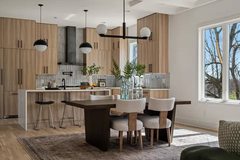 a kitchen with granite countertop a sink a stove and cabinets