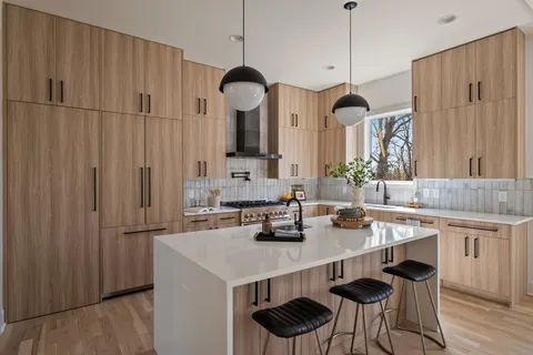 a kitchen with stainless steel appliances a sink stove and cabinets