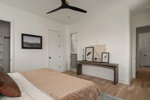 a view of a hallway with wooden floor and staircase