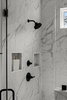 an empty room with wooden floor a ceiling fan and windows