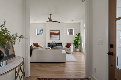 a living room with furniture a ceiling fan and a window