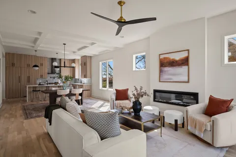 a living room with furniture and kitchen view