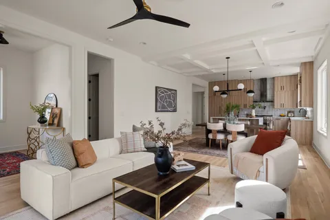 a living room with furniture potted plant and a window