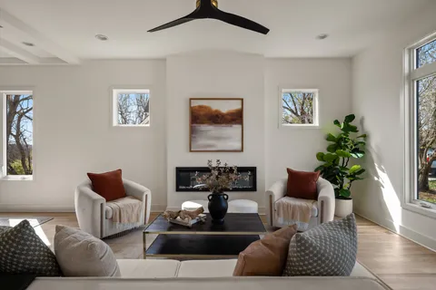 a living room with furniture and a floor to ceiling window