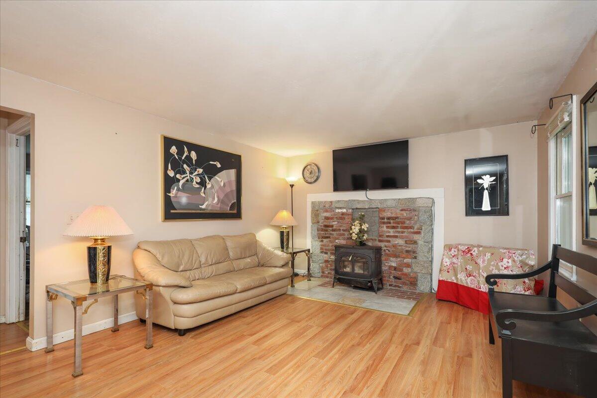 22 Dana Road Forestdale, MA 02644 - Photo 3 of 15 a living room with furniture a flat screen tv and a fireplace