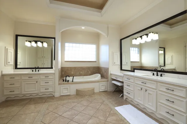 a bedroom with a large bed and a flat tv screen