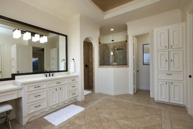 a spacious bathroom with a granite countertop sink mirror and a