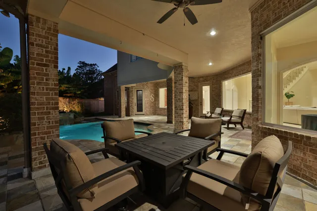 a view of a backyard with sitting area
