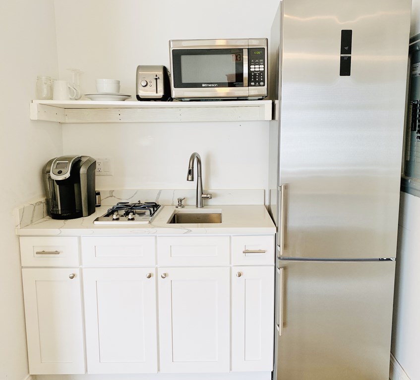 4 Bay Street, Unit A0 Hull, MA 02045 - Photo 12 of 23 a kitchen with a refrigerator and a sink