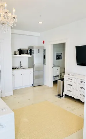 a view of a bedroom with furniture and flat screen tv