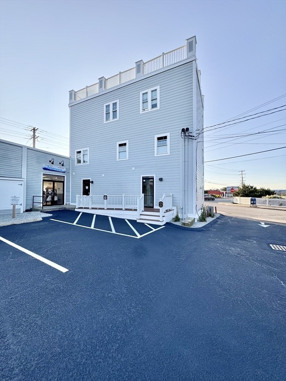 4 Bay Street, Unit A0 Hull, MA 02045 - Photo 17 of 23 a view of kitchen with two windows and a fireplace