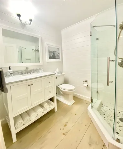 a spacious bathroom with a double vanity sink toilet mirror and bathtub