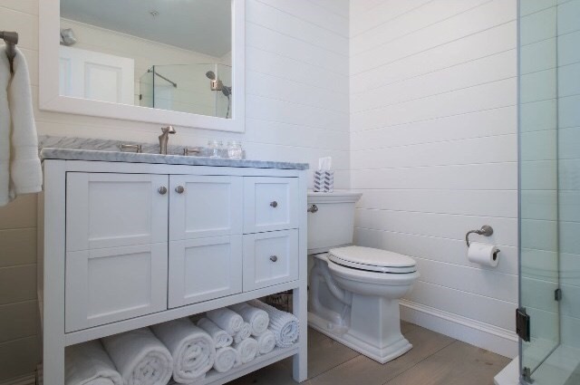 4 Bay Street, Unit A0 Hull, MA 02045 - Photo 19 of 23 a bathroom with a granite countertop toilet sink and mirror