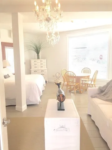 a bedroom with furniture and a large mirror