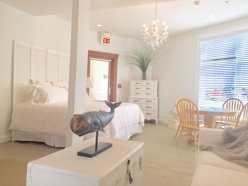 4 Bay Street, Unit A0 Hull, MA 02045 - Photo 4 of 23 a living room with furniture and a chandelier