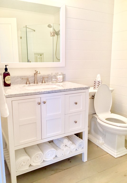 4 Bay Street, Unit A0 Hull, MA 02045 - Photo 6 of 23 a bathroom with a sink a toilet and mirror