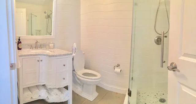 a bathroom with a sink toilet and shower