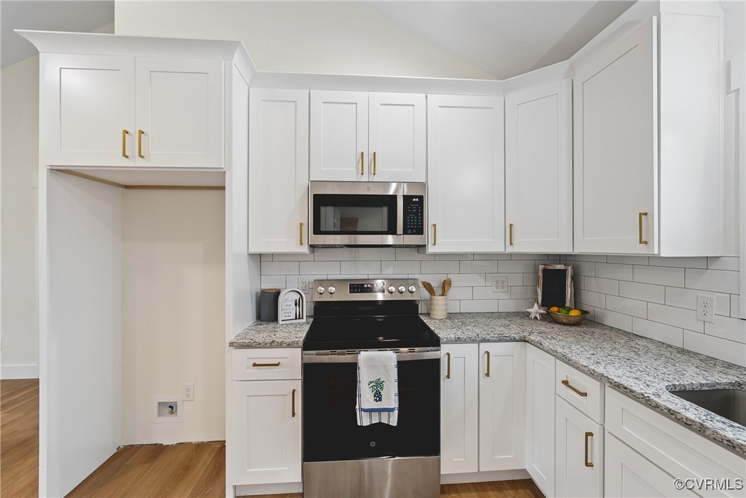 26428 Dejarnette Lane Ruther Glen, VA 22546 - Photo 11 of 27 a kitchen with white cabinets and black appliances