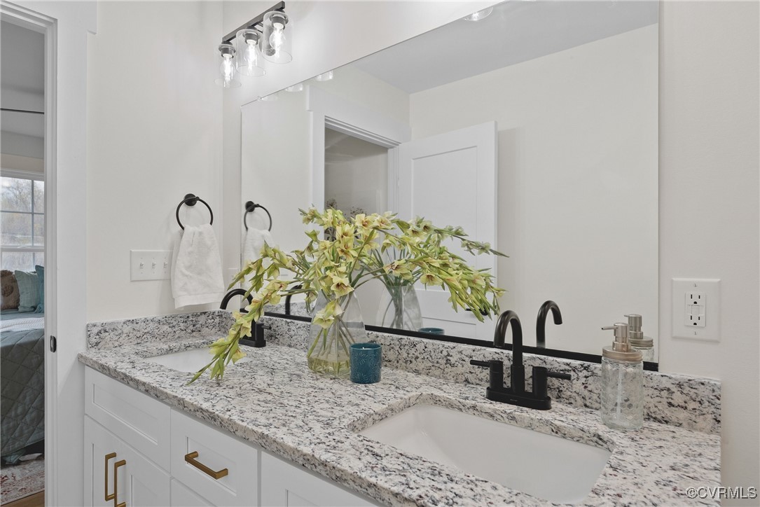 26428 Dejarnette Lane Ruther Glen, VA 22546 - Photo 17 of 27 a bathroom with a granite countertop sink and a mirror