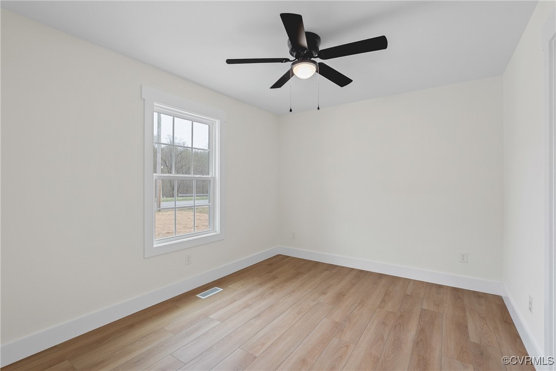 26428 Dejarnette Lane Ruther Glen, VA 22546 - Photo 20 of 27 an empty room with wooden floor and windows