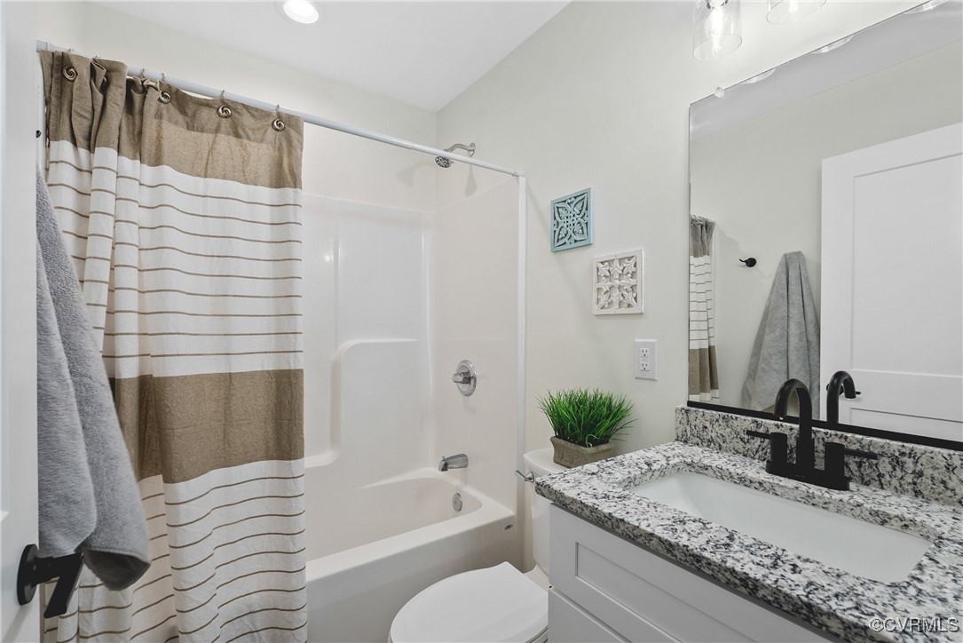 26428 Dejarnette Lane Ruther Glen, VA 22546 - Photo 24 of 27 a bathroom with a granite countertop tub sink and mirror