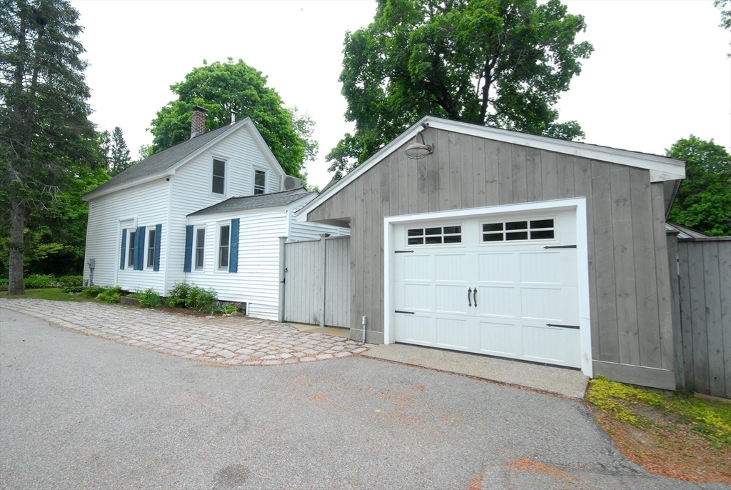 1832 Main Street Concord, MA 01742 - Photo 10 of 25 a view of a white house with a yard and garage