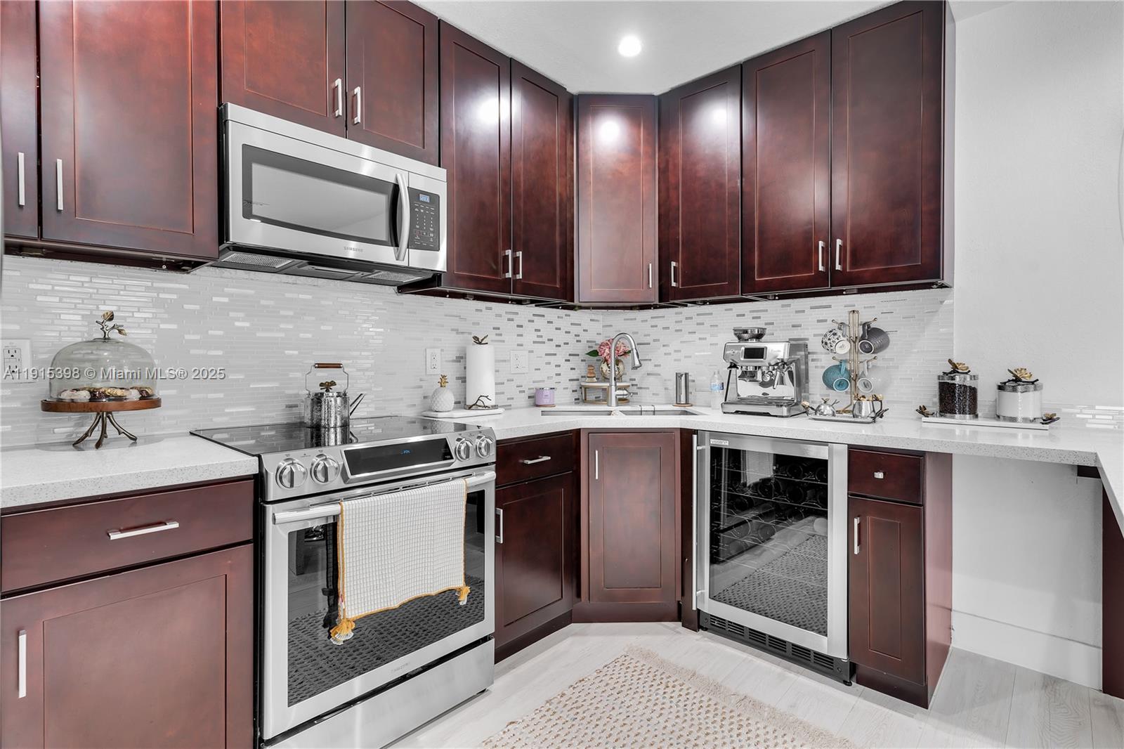 444 Southwest 64th Avenue Miami, FL 33144 - Photo 11 of 70 a kitchen with sink a microwave and cabinets