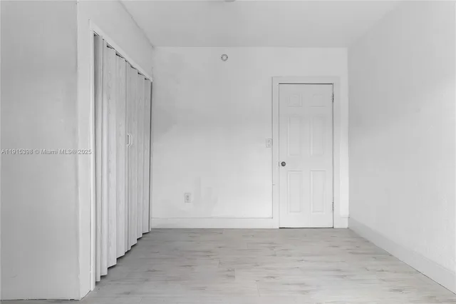 a view of a patio with table and chairs potted plants and large tree