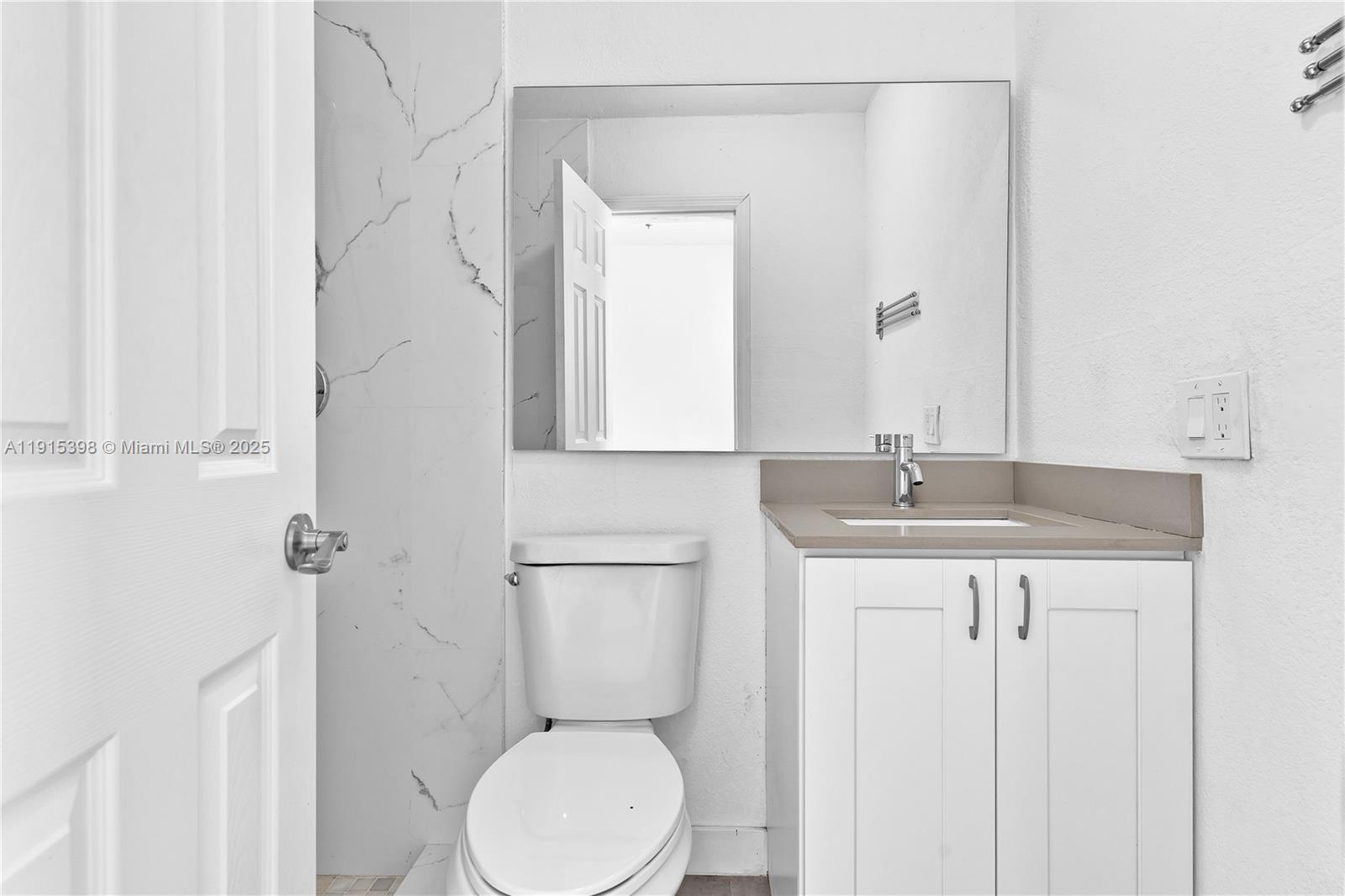 444 Southwest 64th Avenue Miami, FL 33144 - Photo 27 of 70 a bathroom with a toilet a sink a mirror and vanity