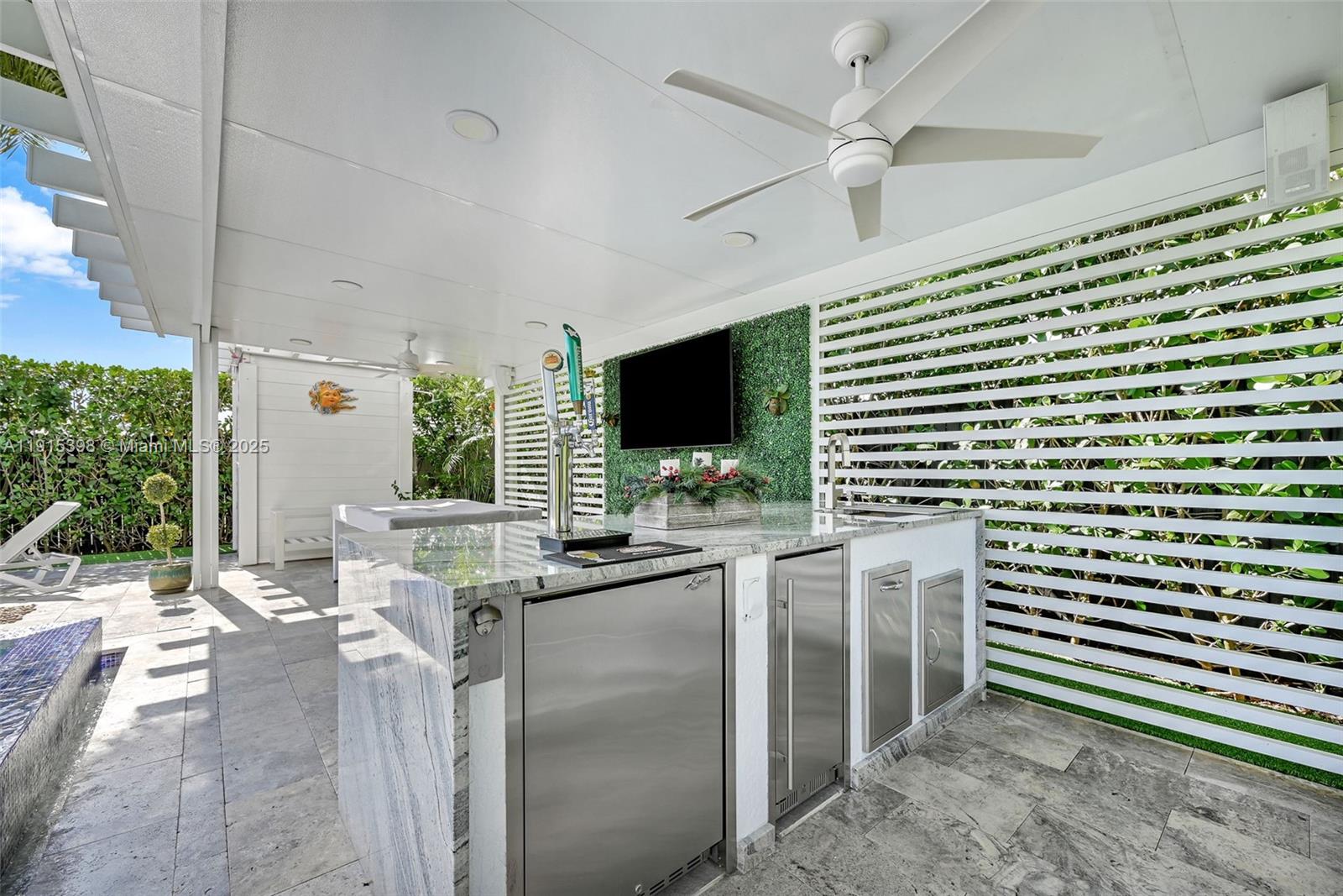 444 Southwest 64th Avenue Miami, FL 33144 - Photo 48 of 70 a kitchen with stainless steel appliances kitchen island granite countertop a stove a sink and a microwave