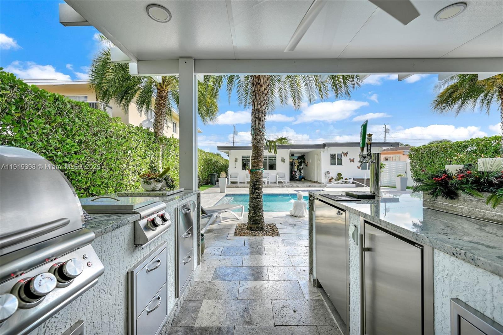 444 Southwest 64th Avenue Miami, FL 33144 - Photo 50 of 70 a kitchen with stainless steel appliances granite countertop a sink and a stove