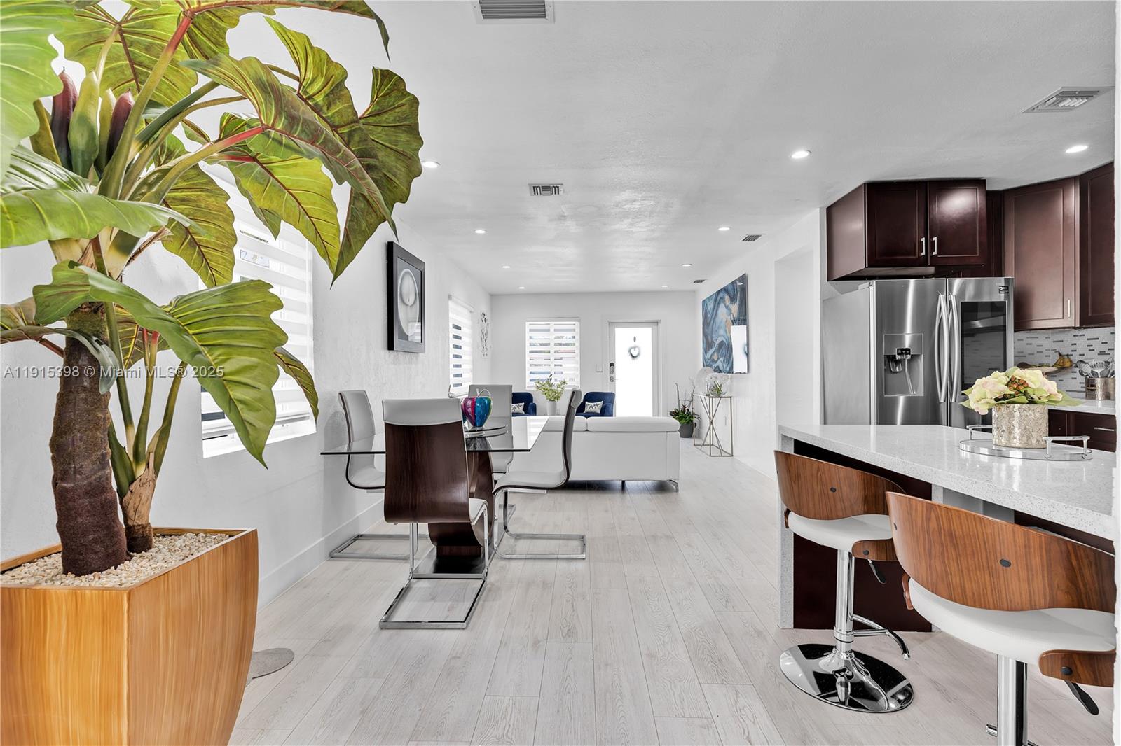 444 Southwest 64th Avenue Miami, FL 33144 - Photo 9 of 70 a living room with furniture a fireplace furniture and a flat screen tv