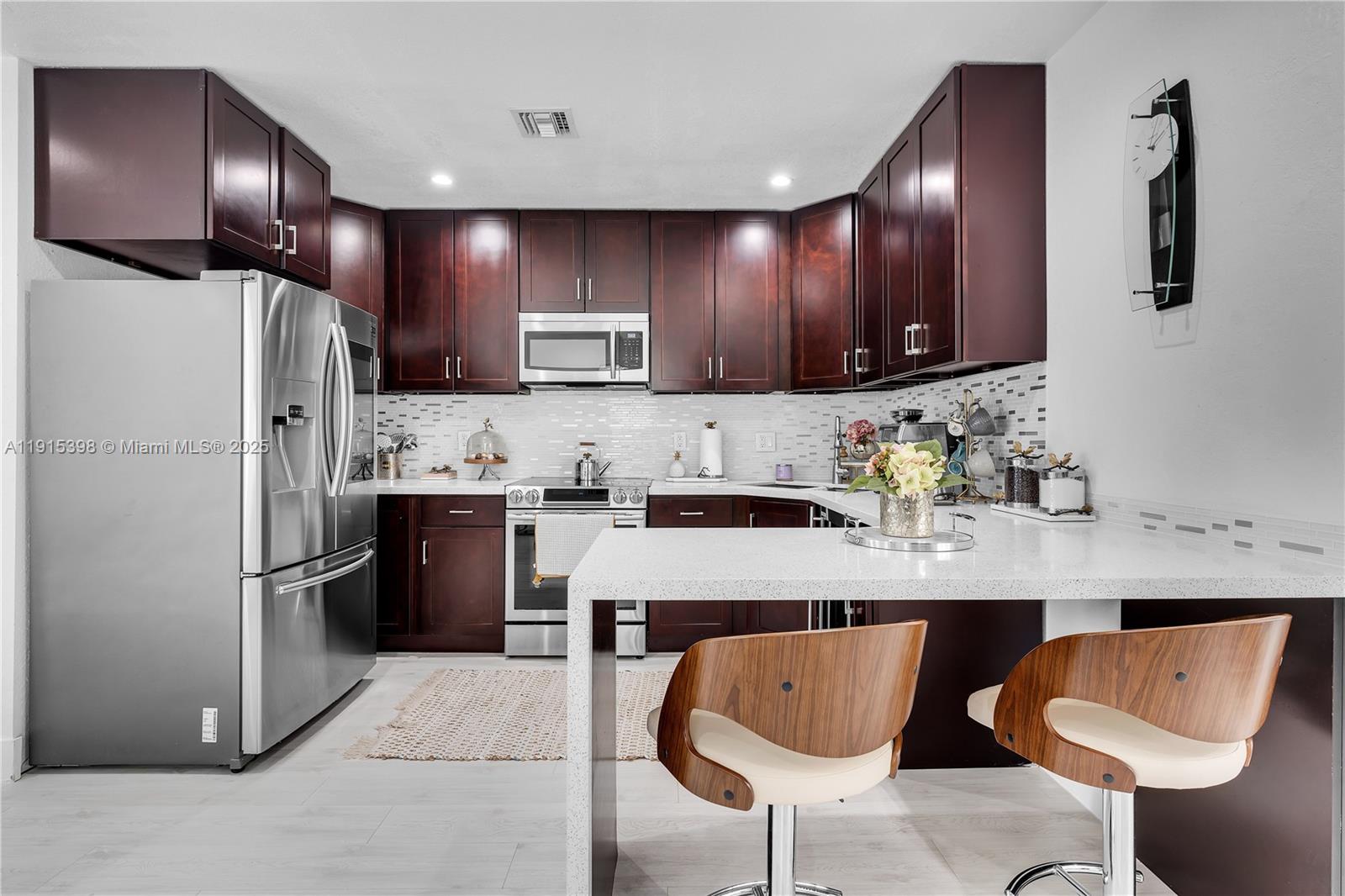 444 Southwest 64th Avenue Miami, FL 33144 - Photo 10 of 70 a kitchen with stainless steel appliances granite countertop a sink refrigerator and cabinets
